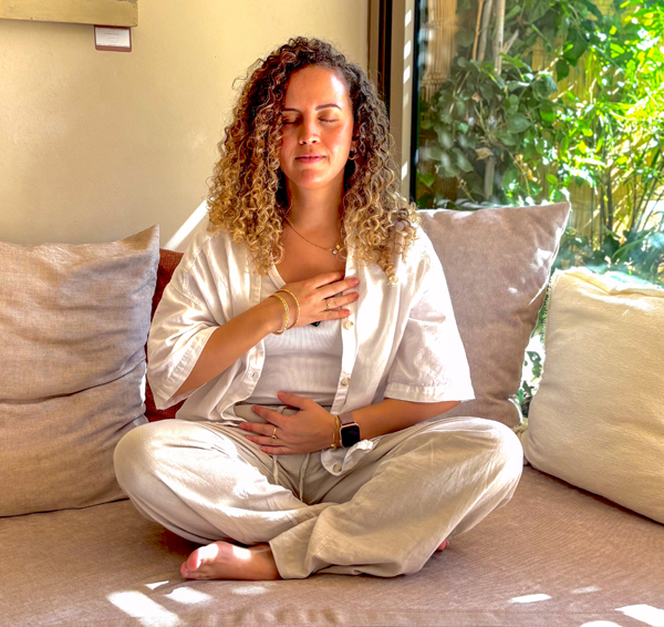 afifa teacher with hand on chest looking introspective