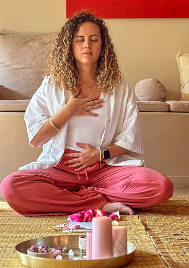 afifa looking at the camera sitting on the floor